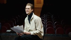Student reading their notes in a theatre